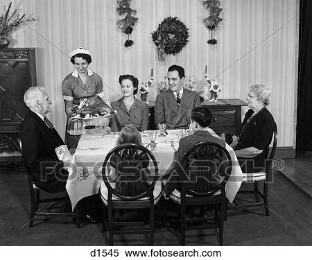 1940S Two Generation Family In Dining Room Being Served Christmas Turkey By Maid View Large Photo Image Stock Photography - 1940S Two Generation Family In Dining Room Being Served Christmas Turkey By Maid . Fotosearch
