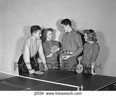 Picture - 1940S Two Teen Couples Boys Girls Hold Paddles By Ping Pong Table . Fotosearch
