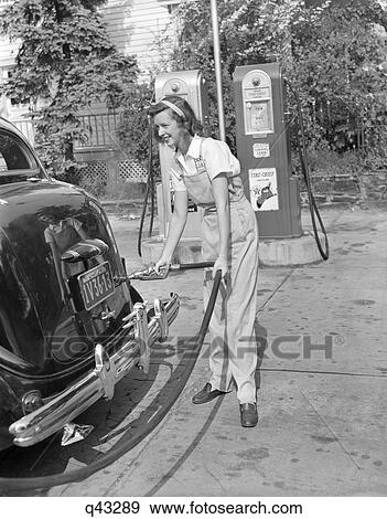 1940S Woman Gas Station Attendant Filling Car Tank View Large Photo Image Stock Photo - 1940S Woman Gas Station Attendant Filling Car Tank . Fotosearch
