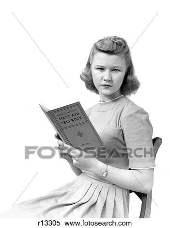 1940S Woman Seated Facing Viewer While Holding A Book Entitled First Aid Textbook View Large Photo Image Stock Photography - 1940S Woman Seated Facing Viewer While Holding A Book Entitled First Aid Textbook. Fotosearch
