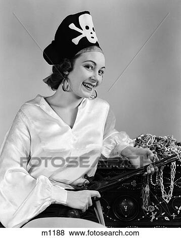 1940S Woman Wearing Pirate Costume Holding Rifle In Lap Leaning On Treasure Trunk Indoor View Large Photo Image Stock Photo - 1940S Woman Wearing Pirate Costume Holding Rifle In Lap Leaning On Treasure Trunk Indoor . Fotosearch