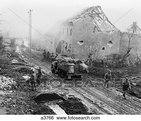 Stock Photograph - 1940S World War Tank American Armor And Infantry Moving Into A Still Smoking German Town Devastation Ruins War . Fotosearch