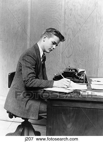 1940S Young Man Sitting At Desk Writing Manual Typewriter Study College Office Businessman Or Student View Large Photo Image Stock Photo - 1940S Young Man Sitting At Desk Writing Manual Typewriter Study College Office Businessman Or Student. Fotosearch