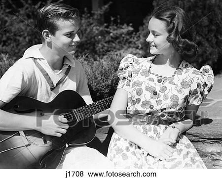 1940S Young Teen Couple Boy Playing Guitar Serenading Smiling Girl View Large Photo Image Stock Photo - 1940S Young Teen Couple Boy Playing Guitar Serenading Smiling Girl. Fotosearch
