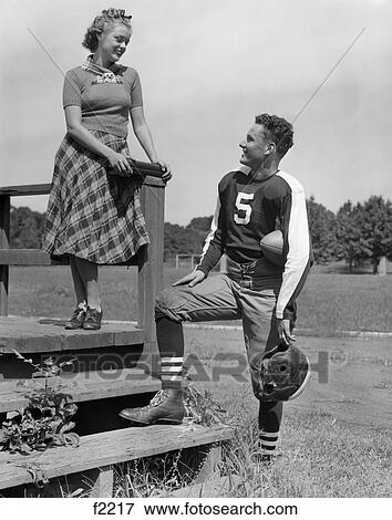 1940S Young Teen Football Player Talking To Teen Girl On Steps View Large Photo Image Stock Photo - 1940S Young Teen Football Player Talking To Teen Girl On Steps . Fotosearch