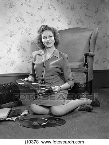1940S Young Woman Teen Sitting On Floor By Chair Holding Sorting 78Rpm Phonograph Records View Large Photo Image Stock Photo - 1940S Young Woman Teen Sitting On Floor By Chair Holding Sorting 78Rpm Phonograph Records . Fotosearch