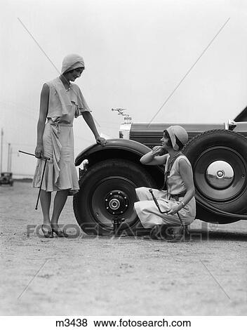 Stock Photo - 1950 1950S Retro Women Car Flat Tire Repair Auto Jack Problem . Fotosearch