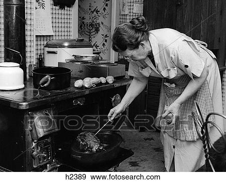 1950S Housewife Testing Roast Beef In Oven To See If It Is Done Cooking View Large Photo Image Stock Photo - 1950S Housewife Testing Roast Beef In Oven To See If It Is Done Cooking . Fotosearch