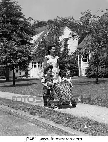 1950S Mom On Sidewalk Pushing Wicker Shopping Basket With Daugher And Son In Cowboy Hat Walking Beside Her View Large Photo Image Stock Image - 1950S Mom On Sidewalk Pushing Wicker Shopping Basket With Daugher And Son In Cowboy Hat Walking Beside Her . Fotosearch