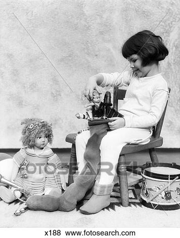 Stock Photo - Gifts Stocking Toys Dolls Girl Drum Retro 1940 1940S 1950 1950S. Fotosearch