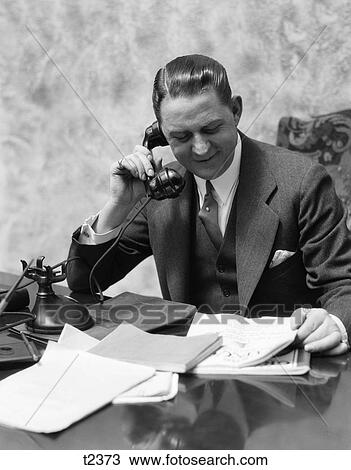 Stock Photo of 1920 1920S 1930 1930S Man Sitting At Desk Talking On ...