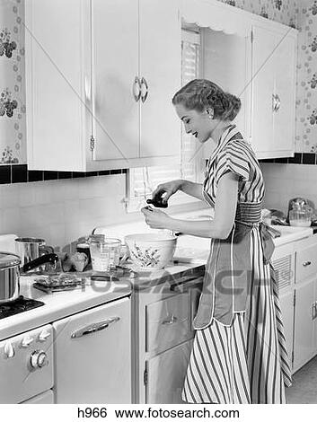 Stock Photograph - Woman Kitchen Baking Mixing Bowl Apron 1940S Retro. Fotosearch