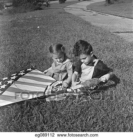 1940 Girl And Boy Sitting In Grass Lawn Holding American Flag Style Kite View Large Photo Image Stock Image - 1940 Girl And Boy Sitting In Grass Lawn Holding American Flag Style Kite. Fotosearch