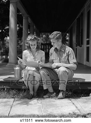 Stock Image - 1940S 1950S Retro Couple Man Woman Sitting Porch Reading. Fotosearch