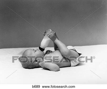1940S Baby Prone Drinking From Milk Bottle Held With Feet View Large Photo Image Stock Photo - 1940S Baby Prone Drinking From Milk Bottle Held With Feet . Fotosearch
