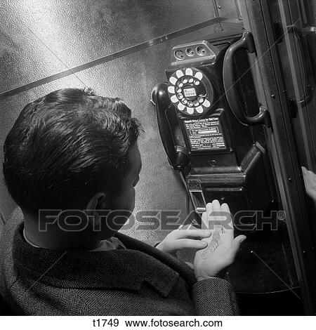 1950 1950S 1960 1960S Man Counting Change In Hand At Telephone Booth View Large Photo Image Stock Photo - 1950 1950S 1960 1960S Man Counting Change In Hand At Telephone Booth . Fotosearch