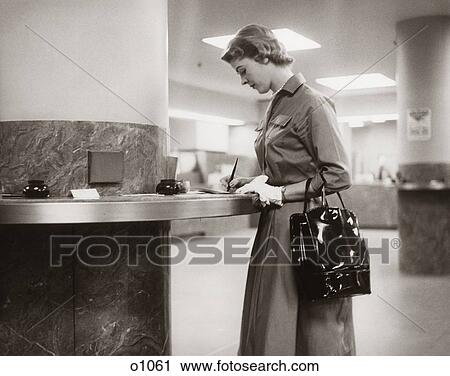 1950 1950S 1960 1960S Woman Handbag On Arm Earing Gloves Filling Out Deposit Slip Bank Counter Writing Banking View Large Photo Image Stock Image - 1950 1950S 1960 1960S Woman Handbag On Arm Earing Gloves Filling Out Deposit Slip Bank Counter Writing Banking . Fotosearch