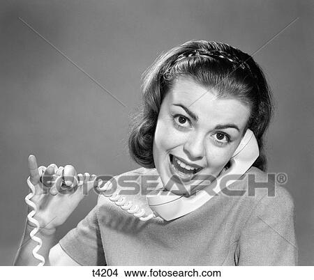 1950 1950S 1960 1960S Young Woman Talking On Telephone Cord Wrapped In Fingers View Large Photo Image Picture - 1950 1950S 1960 1960S Young Woman Talking On Telephone Cord Wrapped In Fingers . Fotosearch
