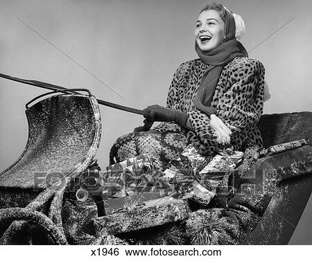 1950 1950S Christmas Sleigh Presents Scarf Hat Smiling Woman View Large Photo Image Stock Photograph - 1950 1950S Christmas Sleigh Presents Scarf Hat Smiling Woman. Fotosearch