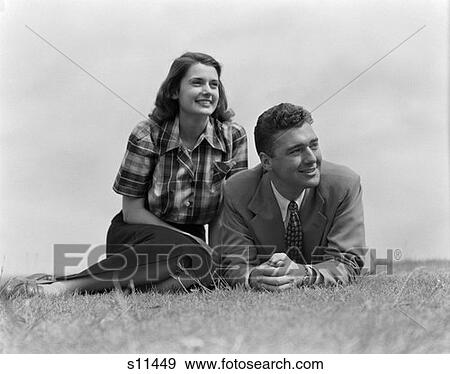 1950 1950S Couple Lying On Grass View Large Photo Image Stock Photo - 1950 1950S Couple Lying On Grass . Fotosearch