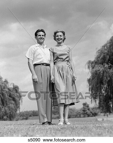 1950 1950S Couple Standing On Lawn View Large Photo Image Stock Image - 1950 1950S Couple Standing On Lawn . Fotosearch