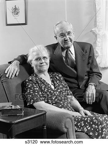 1950 1950S Elderly Couple Sitting On Couch Smiling View Large Photo Image Stock Image - 1950 1950S Elderly Couple Sitting On Couch Smiling . Fotosearch