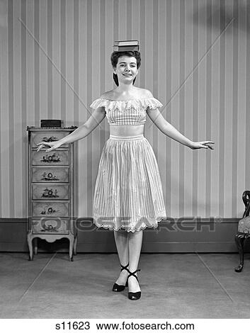 1950 1950S Girl In Dress Balancing Books On Head View Large Photo Image Stock Image - 1950 1950S Girl In Dress Balancing Books On Head . Fotosearch