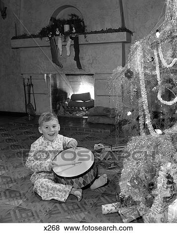 1950 1950S Little Boy Playing Toy Drum By Christmas Tree And Fireplace View Large Photo Image Stock Photo - 1950 1950S Little Boy Playing Toy Drum By Christmas Tree And Fireplace. Fotosearch