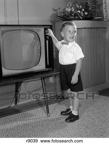 1950 1950S Little Boy Playing With Television Dial View Large Photo Image Stock Photo - 1950 1950S Little Boy Playing With Television Dial . Fotosearch