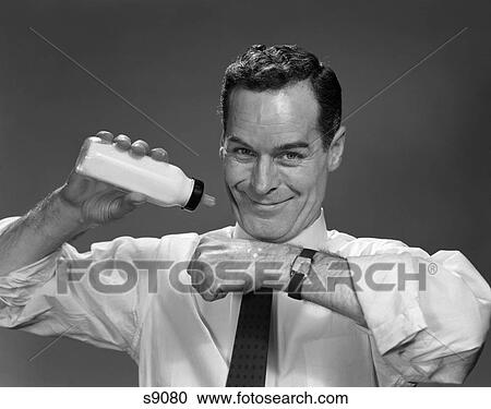 1950 1950S Man Holding Bottle Of Milk Checking Temperature On Hand View Large Photo Image Stock Image - 1950 1950S Man Holding Bottle Of Milk Checking Temperature On Hand . Fotosearch
