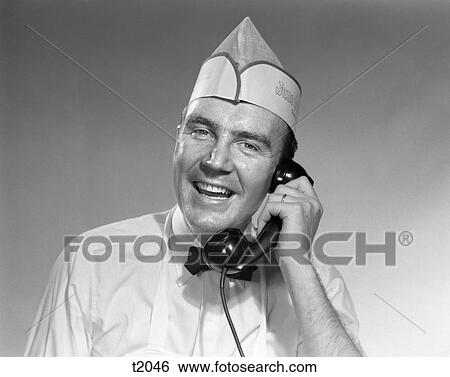 1950 1950S Man In Baker Uniform Talking On Telephone View Large Photo Image Stock Photograph - 1950 1950S Man In Baker Uniform Talking On Telephone . Fotosearch
