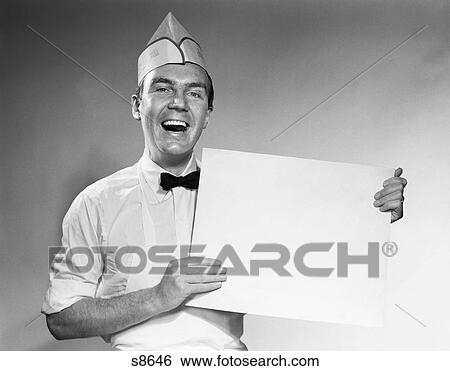 1950 1950S Man In Baker'S Uniform Holding Sign View Large Photo Image Stock Photograph - 1950 1950S Man In Baker'S Uniform Holding Sign . Fotosearch