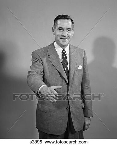 1950 1950S Man In Suit Extending Arm Out To Shake Hands View Large Photo Image Stock Photography - 1950 1950S Man In Suit Extending Arm Out To Shake Hands . Fotosearch