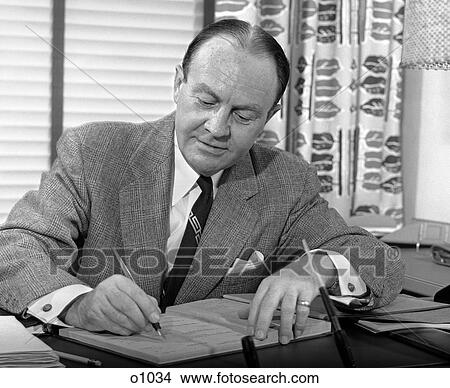 1950 1950S Man Sitting At Desk Writing View Large Photo Image Picture - 1950 1950S Man Sitting At Desk Writing . Fotosearch