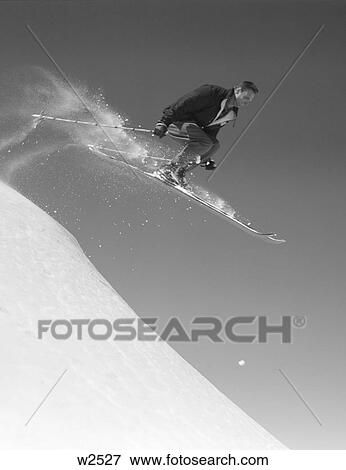 1950 1950S Man Skiing Downhill Off Slope Jumping Into Air Mid-Air Ski Skis Sports Winter Snow Skier Men View Large Photo Image Stock Photo - 1950 1950S Man Skiing Downhill Off Slope Jumping Into Air Mid-Air Ski Skis Sports Winter Snow Skier Men. Fotosearch
