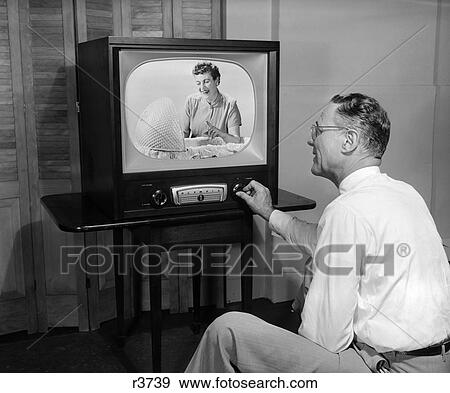 1950 1950S Man Tuning Television To A Picture Of Woman Looking Into Bassinet Pointing Finger View Large Photo Image Stock Photo - 1950 1950S Man Tuning Television To A Picture Of Woman Looking Into Bassinet Pointing Finger . Fotosearch
