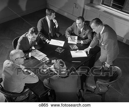 Stock Photography - 1950 1950S Men Meeting Table Paperwork Business . Fotosearch