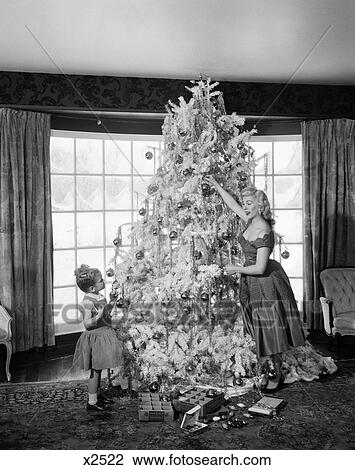 1950 1950S Mother And Daughter Decorating Christmas Tree Ornaments View Large Photo Image Stock Image - 1950 1950S Mother And Daughter Decorating Christmas Tree Ornaments . Fotosearch