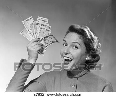 1950 1950S Portrait Of Woman Holding Up Money With Exaggerated Smile View Large Photo Image Stock Image - 1950 1950S Portrait Of Woman Holding Up Money With Exaggerated Smile . Fotosearch