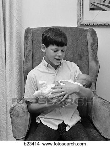 1950 1950S Retro Boy Baby Infant Holding Chair View Large Photo Image Picture - 1950 1950S Retro Boy Baby Infant Holding Chair . Fotosearch