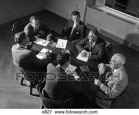 Stock Photo - 1950 1950S Retro Conference Table Men Meeting Paperwork Business Deal . Fotosearch