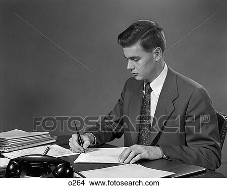 Picture - 1950 1950S Retro Man Business Desk Pen Paperwork Suit Tie Telephone . Fotosearch