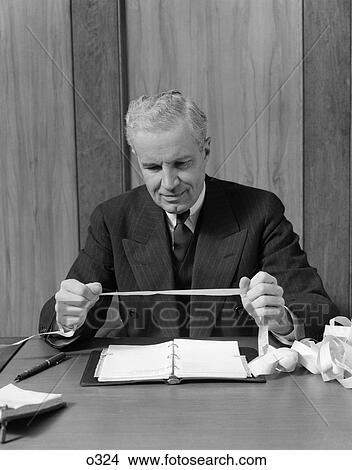 1950 1950S Retro Man Ticker Tape Finance Stock Market Business Suit View Large Photo Image Picture - 1950 1950S Retro Man Ticker Tape Finance Stock Market Business Suit . Fotosearch