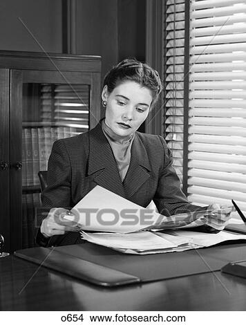1950 1950S Retro Woman Business Desk Reading Paperwork Pen Bookcase View Large Photo Image Picture - 1950 1950S Retro Woman Business Desk Reading Paperwork Pen Bookcase . Fotosearch