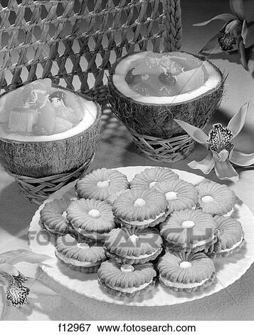1950 1950S Still Life Of Filled Cookies On A Plate And Coconuts With Fruit Filling View Large Photo Image Stock Photo - 1950 1950S Still Life Of Filled Cookies On A Plate And Coconuts With Fruit Filling . Fotosearch