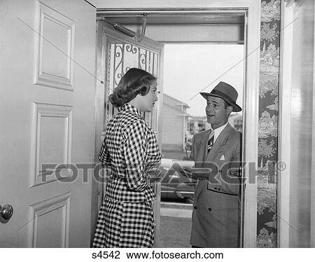 1950 1950S Woman Answering Door To Man In Business Suit And Hat Writing View Large Photo Image Stock Image - 1950 1950S Woman Answering Door To Man In Business Suit And Hat Writing . Fotosearch
