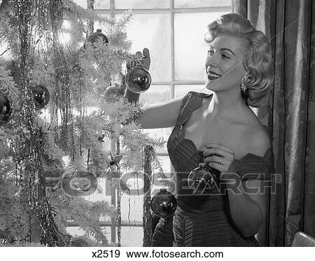 1950 1950S Woman Decorating Christmas Tree With Christmas Balls View Large Photo Image Stock Photo - 1950 1950S Woman Decorating Christmas Tree With Christmas Balls . Fotosearch