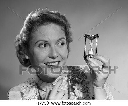 1950 1950S Woman Holding Up Hourglass View Large Photo Image Stock Photo - 1950 1950S Woman Holding Up Hourglass . Fotosearch