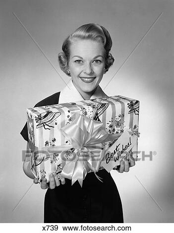 1950 1950S Woman Holding Wrapped Present With Best Wishes Tag Studio View Large Photo Image Stock Photo - 1950 1950S Woman Holding Wrapped Present With Best Wishes Tag Studio . Fotosearch
