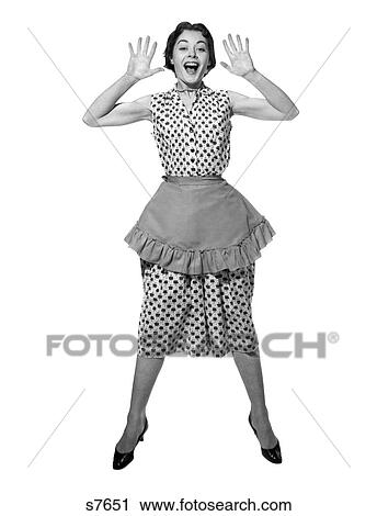 Stock Image - 1950 1950S Woman In Apron Jumping Exaggerated Expression . Fotosearch